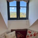 Dormer window with seating, looking out on the countryside